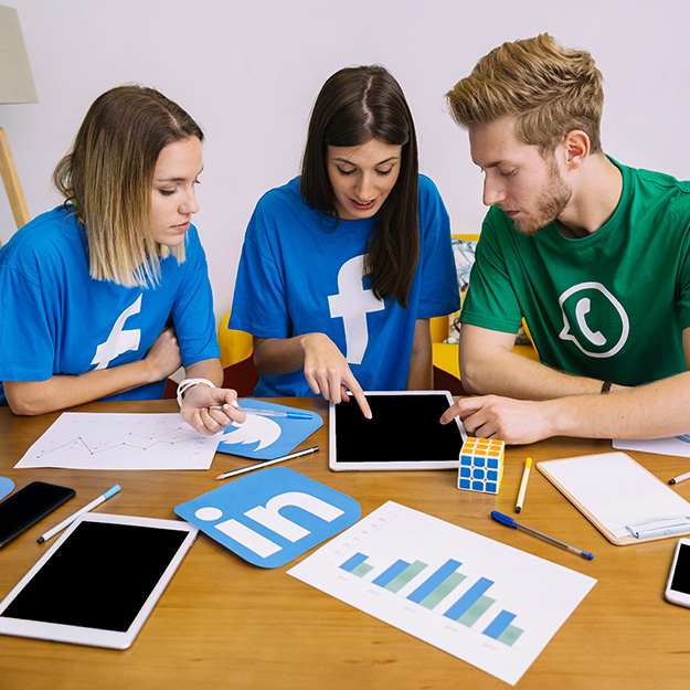 carre-team-social-media-networking-looking-digital-tablet-office